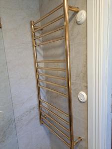 a metal towel rack in a shower in a bathroom at Malistorpets Rosor in Varberg