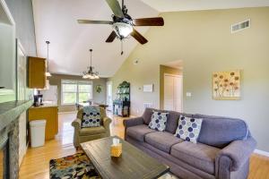 a living room with a couch and a ceiling fan at Cozy Resort-Style Escape on Taylorsville Lake! in Taylorsville