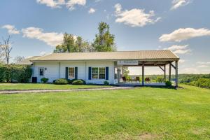 a white house with a gazebo in a field at Cozy Resort-Style Escape on Taylorsville Lake! in Taylorsville