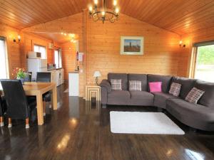 a living room with a couch and a table at Hazel Lodge in Bodmin