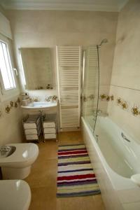 a bathroom with a toilet and a tub and a sink at Villa Los Níspero de Paco in Canillas de Albaida +20 photos