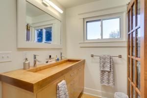 a bathroom with a wooden sink and a mirror at Indiana Vacation Rental - Walk to Syracuse Lake! in Syracuse +29 photos