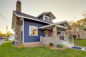 a blue house with a stone pillar at Indiana Vacation Rental - Walk to Syracuse Lake! in Syracuse