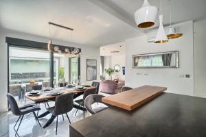een eetkamer en een woonkamer met een tafel en stoelen bij www VillaCelestial com in Split