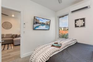 a bedroom with a bed and a living room at Red Desert Loft Resort 37 Pickleball Courts, Foosball, Resort Pool with Waterslide & Jacuzzi! in St. George +31 photos