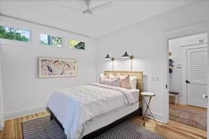 a white bedroom with a large bed and a window at Southern Charm in Santa Rosa Beach +38 photos