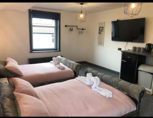 a living room with two beds and a flat screen tv at RESIDENCY LUXURY SEAFRONT HOTEL in Blackpool