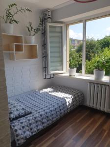 a bed in a room with a window at STELLA 6 in Sanok