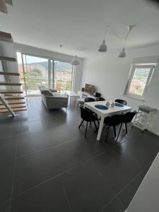 a living room with a table and chairs at Apartmani Kamil in Marina