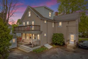 a large house with a porch and a balcony at Cozy house close to Brandeis, Bentley, Moody St in Waltham