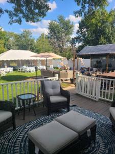 a wooden deck with chairs and a table and a table at Glen Ellyn Countryside Home in Glen Ellyn