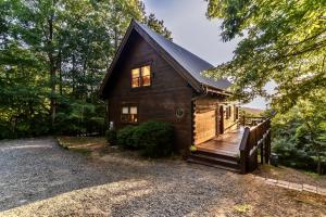 a log cabin with a wooden deck and a porch at Amazing Views~Secluded Retreat~HotTub~GameRoom in Mineral Bluff