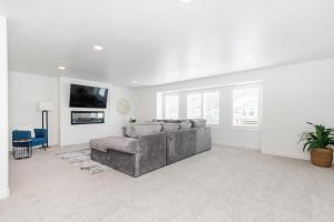 a living room with a couch and a tv at Bear Lake - Mike's Market 3BR2BA EV Charger in Garden City