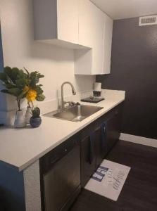 a kitchen with a sink and a counter with a paper on the floor at 2bedroom Downtown Los Angeles pool and gym onsite. in Los Angeles