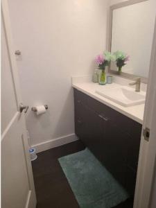 a bathroom with a sink and a mirror at 2bedroom Downtown Los Angeles pool and gym onsite. in Los Angeles
