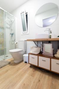 a bathroom with a toilet and a sink and a shower at Apartment Granollers Up Live II in Granollers