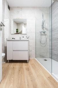 a bathroom with a white vanity and a shower at Apartment Granollers Up Live II in Granollers