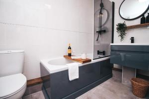 a bathroom with a white toilet and a sink at Commercial House, By Solace Stays in Newport +35 photos