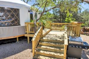 a wooden stairway leading to a yurt with a tree at Luxury Yurt, Alpacas and llamas near Downtown Wimberley and Wineries in Wimberley