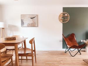 a dining room with a table and chairs at Hollybush Apartment, by Solace Stays in Newport