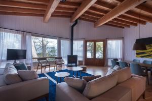 a large living room with couches and a tv at Savia Madre Eco-lodge in Villa La Angostura
