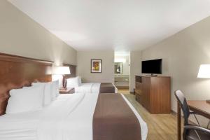 a hotel room with two beds and a flat screen tv at Best Western Athens Inn in Athens