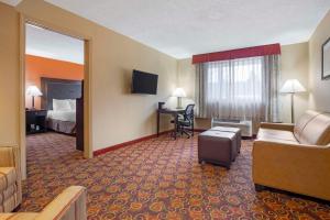 a hotel room with a couch and a bed and a desk at Best Western Plus The Inn at Sharon/Foxboro in Sharon