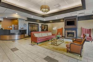 a living room with a couch and a fireplace at Best Western Plus The Charles Hotel in St. Charles