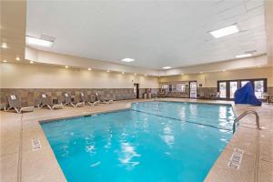 a pool with blue water in a hotel room at Best Western Plus The Charles Hotel in St. Charles