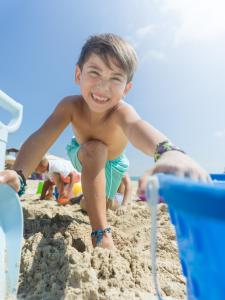 a young boy playing in the sand on the beach at Paradisus Cancun All Inclusive in Cancún