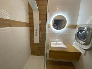 a bathroom with a sink and a mirror at 3 pièces la Foux d Allos vue montagne et station in La Foux +19 photos