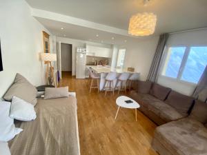 a living room with a couch and a table at 3 pièces la Foux d Allos vue montagne et station in La Foux