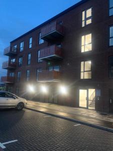 a car parked in front of a building at night at Brand New Posh 1 Bed Lakeside Flat No parties No Events in West Thurrock