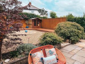 a garden with a bench and a wooden fence at Ty-Fry House, by Solace Stays in Cardiff