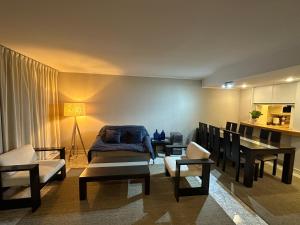 a living room with a bed and a table and chairs at San Alfonso Mágico - Vista Panorámica - Laguna y Playa Privada in Algarrobo