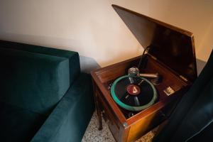 an old fashioned telephone next to a green couch at Calle Seminario ChioggiaPL in Chioggia