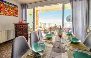 a dining room with a table with a view of the ocean at 3 Bedroom Awesome Apartment In Pineda De Mar in Pineda de Mar
