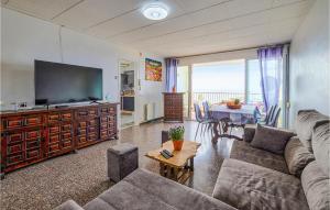 a living room with a couch and a tv at 3 Bedroom Awesome Apartment In Pineda De Mar in Pineda de Mar