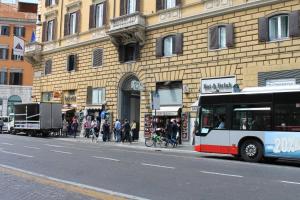 a bus parked on a street next to a building at Hotel Fiori in Rome