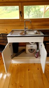 a kitchen with a sink under a counter at NEO resort jezero Bruje in Erdevik