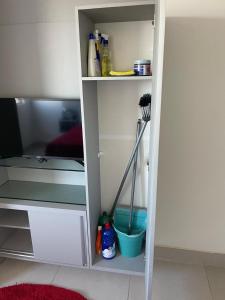 a white cabinet with a broom in a room at Flat Lindo e Aconchegante in Recife