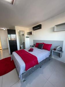 a large bedroom with a large bed with red pillows at Flat Lindo e Aconchegante in Recife