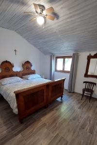 a bedroom with a bed and a ceiling fan at Apartments with a parking space Mali Losinj (Losinj) - 8059 in Mali Lošinj