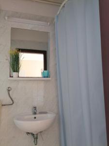 a bathroom with a sink and a mirror at Apartments by the sea Arbanija, Ciovo - 11321 in Trogir