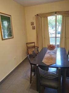 a dining room with a table and chairs and a window at Comodo Departamento in San Juan