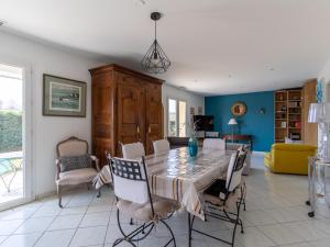 a dining room with a table and chairs at Maison à Mimizan avec jardin et piscine privée pour 6 personnes - FR-1-50-95 in Mimizan