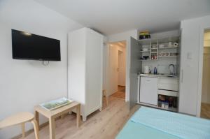 a living room with a tv and a kitchen at Apartments and rooms with WiFi Rovinj - 20857 in Rovinj