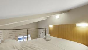 a white bed with towels on top of it at Chalet Hotham 17 in Mount Hotham