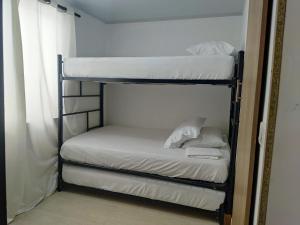 a couple of bunk beds in a room at San San Andrés Magic House 0 by BBBSAI in Buenavista +9 photos