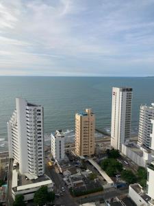 a group of tall buildings next to the ocean at Marina Club Piso 8 in Cartagena de Indias